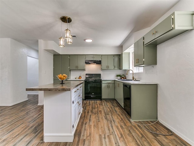 111 S Bristow Ave, Moore, OK 73160 - kitchen with black appliances, green cabinetry, under cabinet range hood, dark wood-type flooring, and dark countertops