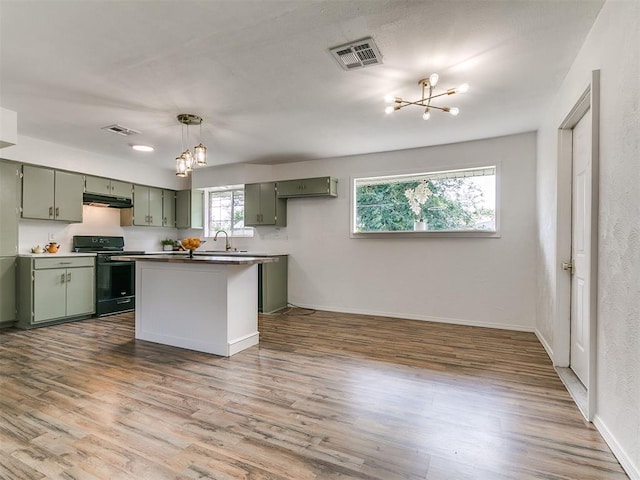 111 S Bristow Ave, Moore, OK 73160 - kitchen featuring black stove, green cabinets, a chandelier, under cabinet range hood, and wood finished floors
