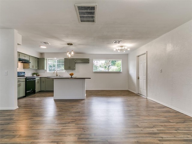 111 S Bristow Ave, Moore, OK 73160 - kitchen with green cabinetry, black stove, a chandelier, and dark wood finished floors
