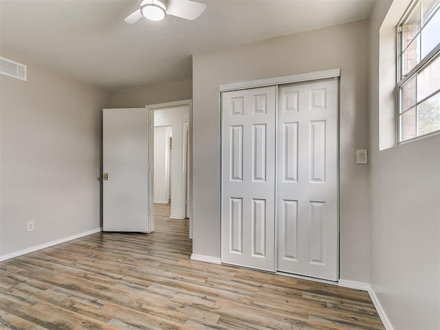 111 S Bristow Ave, Moore, OK 73160 - unfurnished bedroom with wood finished floors, a closet, and a ceiling fan