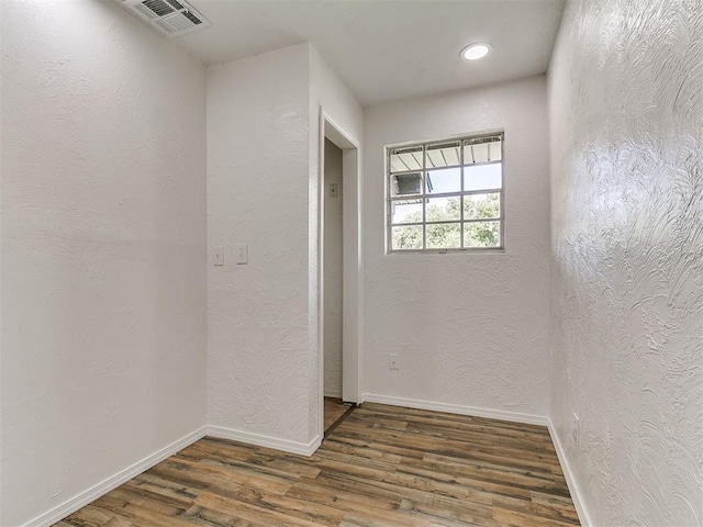 111 S Bristow Ave, Moore, OK 73160 - spare room featuring wood finished floors, a textured wall, and recessed lighting