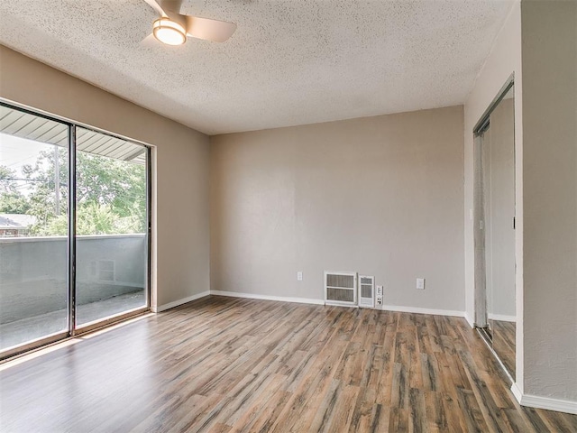 111 S Bristow Ave, Moore, OK 73160 - spare room featuring a textured ceiling, wood finished floors, and ceiling fan
