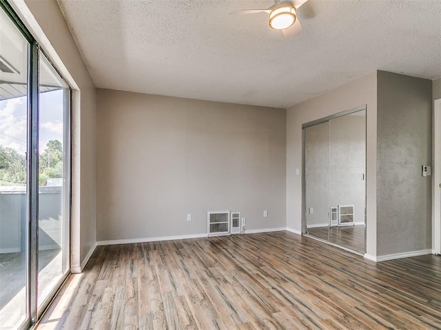 111 S Bristow Ave, Moore, OK 73160 - spare room featuring a textured ceiling, wood finished floors, and ceiling fan