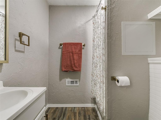111 S Bristow Ave, Moore, OK 73160 - full bath featuring wood finished floors, vanity, and a shower with shower curtain