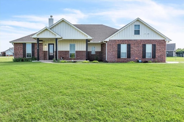 1069 Rheagen Kay Ave, Tuttle, OK 73089 - view of front of home featuring a front lawn, board and batten siding, and a chimney
