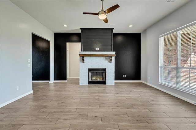 1069 Rheagen Kay Ave, Tuttle, OK 73089 - unfurnished living room with light wood-type flooring, a ceiling fan, recessed lighting, and a fireplace