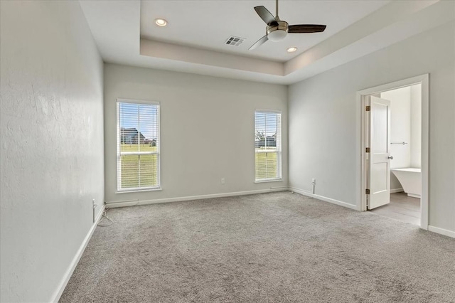 1069 Rheagen Kay Ave, Tuttle, OK 73089 - carpeted spare room with healthy amount of natural light, a ceiling fan, a tray ceiling, and recessed lighting