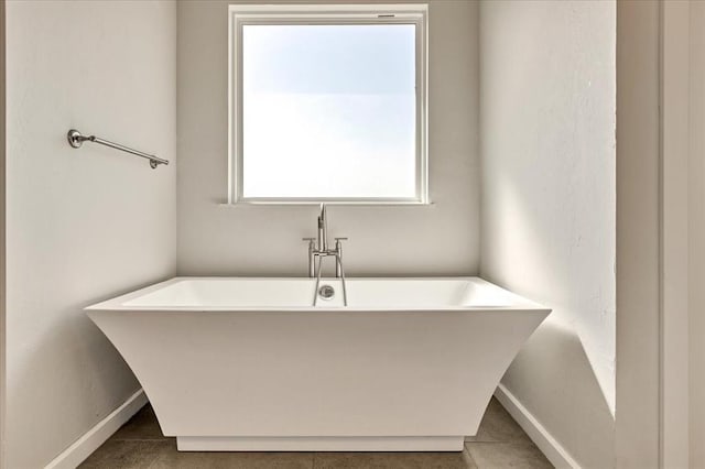 1069 Rheagen Kay Ave, Tuttle, OK 73089 - bathroom featuring a freestanding tub and tile patterned floors