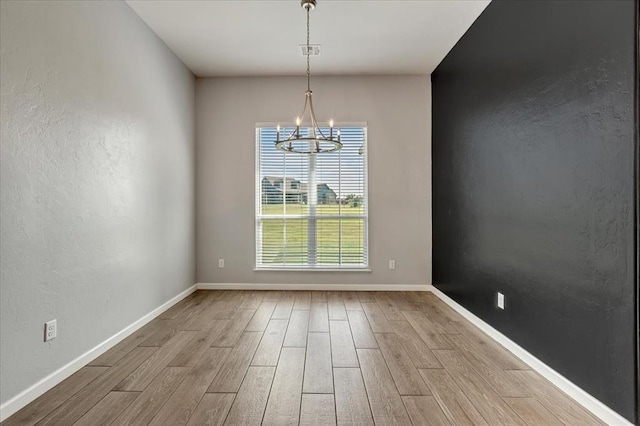 1069 Rheagen Kay Ave, Tuttle, OK 73089 - unfurnished room featuring wood finished floors and a chandelier