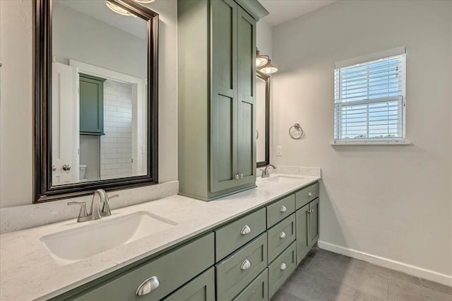 1069 Rheagen Kay Ave, Tuttle, OK 73089 - bathroom featuring double vanity and tile patterned floors