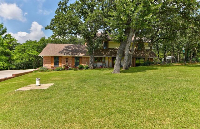 12629 Teakwood Rd, Oklahoma City, OK 73013 - view of front of property featuring a front lawn, brick siding, and a shingled roof