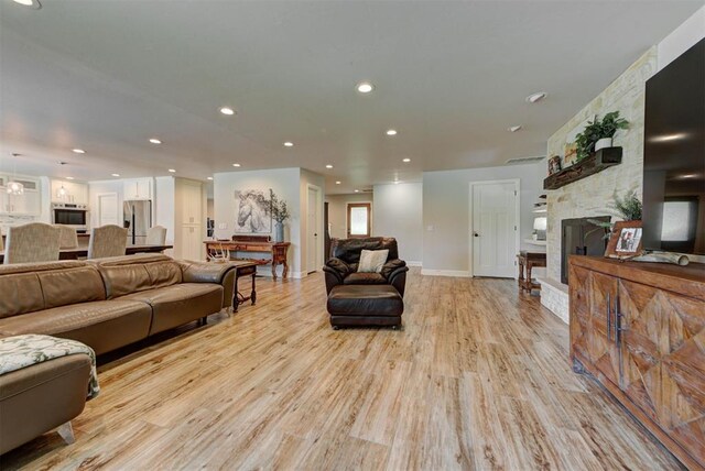 12629 Teakwood Rd, Oklahoma City, OK 73013 - living room featuring a fireplace, light wood-style flooring, and recessed lighting