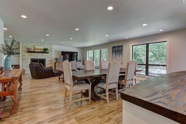 12629 Teakwood Rd, Oklahoma City, OK 73013 - dining area featuring recessed lighting, light wood-type flooring, and a stone fireplace