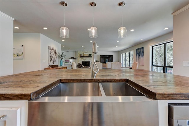 12629 Teakwood Rd, Oklahoma City, OK 73013 - kitchen with open floor plan, recessed lighting, a large fireplace, decorative light fixtures, and stone counters