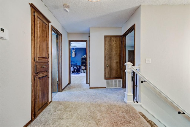 12629 Teakwood Rd, Oklahoma City, OK 73013 - corridor with light colored carpet, an upstairs landing, and a textured ceiling