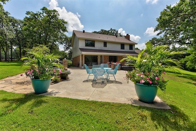 12629 Teakwood Rd, Oklahoma City, OK 73013 - rear view of house with a patio, brick siding, a yard, and a chimney