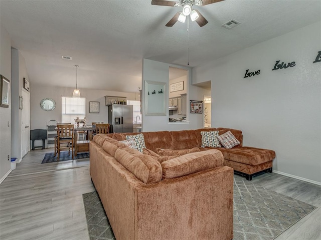 629 NW 121st St, Oklahoma City, OK 73114 - living area with light wood-type flooring and a ceiling fan