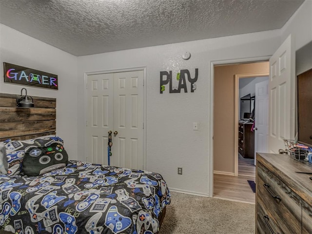 629 NW 121st St, Oklahoma City, OK 73114 - bedroom with a textured ceiling, light carpet, and a closet