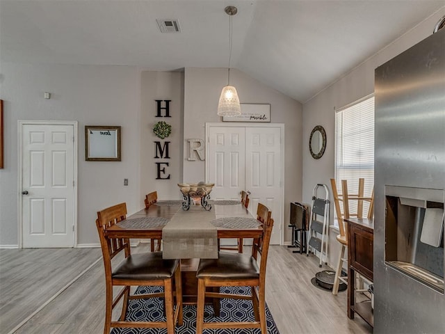 629 NW 121st St, Oklahoma City, OK 73114 - dining area featuring light wood-type flooring and vaulted ceiling