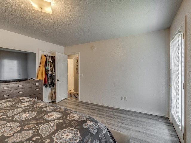 629 NW 121st St, Oklahoma City, OK 73114 - bedroom with wood finished floors and a textured ceiling