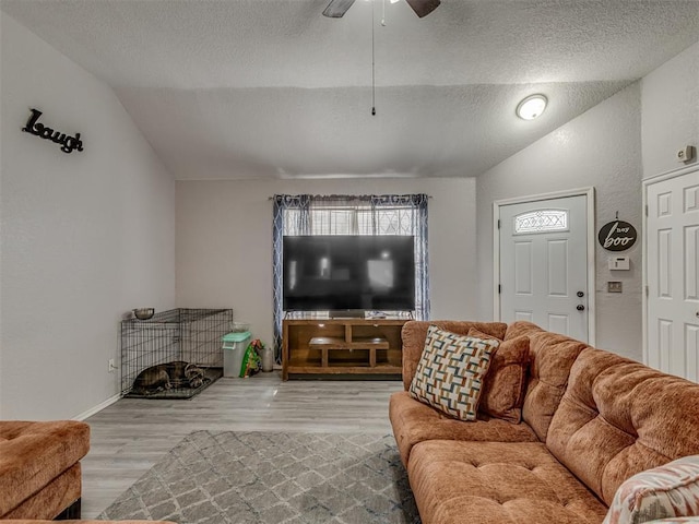 629 NW 121st St, Oklahoma City, OK 73114 - living room with vaulted ceiling, a textured ceiling, ceiling fan, and wood finished floors