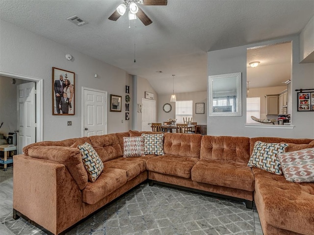 629 NW 121st St, Oklahoma City, OK 73114 - living area featuring ceiling fan and a textured ceiling