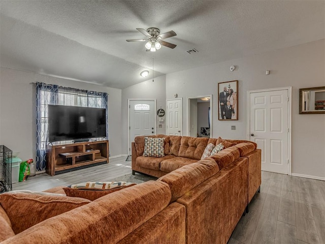 629 NW 121st St, Oklahoma City, OK 73114 - living room with a textured ceiling, a ceiling fan, wood finished floors, and lofted ceiling