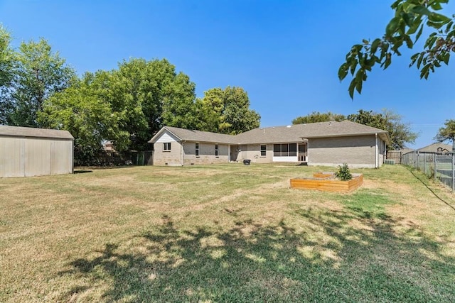 10516 NW 16th St, Yukon, OK 73099 - rear view of property with an outdoor structure and a garden