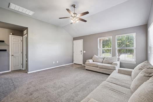 2709 NW 184th St, Edmond, OK 73012 - carpeted living area featuring ceiling fan and lofted ceiling