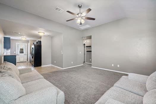 2709 NW 184th St, Edmond, OK 73012 - living room featuring a ceiling fan and light carpet