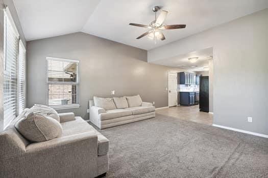 2709 NW 184th St, Edmond, OK 73012 - living room with a ceiling fan, lofted ceiling, and carpet