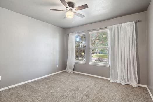 2709 NW 184th St, Edmond, OK 73012 - carpeted empty room featuring baseboards and a ceiling fan