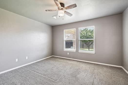 2709 NW 184th St, Edmond, OK 73012 - carpeted spare room featuring baseboards and a ceiling fan