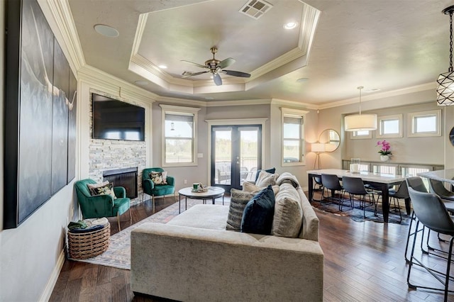 3937 NW 167th Ter, Edmond, OK 73012 - living room featuring a ceiling fan, a stone fireplace, dark wood-type flooring, and crown molding