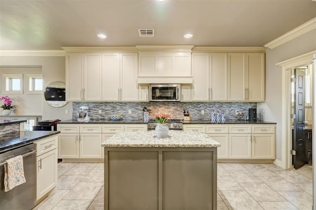 3937 NW 167th Ter, Edmond, OK 73012 - kitchen featuring stainless steel appliances, tasteful backsplash, crown molding, dark stone countertops, and light tile patterned floors