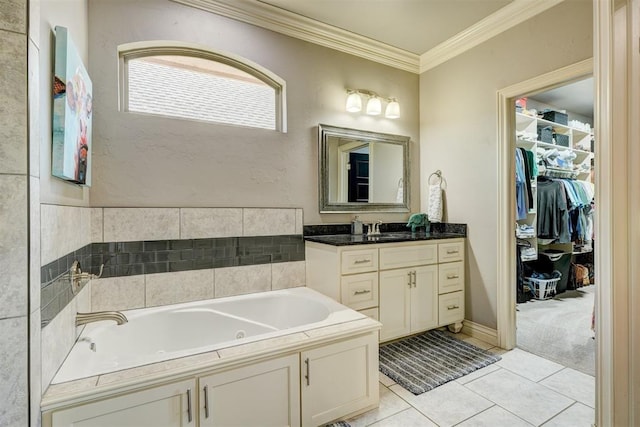 3937 NW 167th Ter, Edmond, OK 73012 - bathroom featuring a jetted tub, vanity, crown molding, tile patterned flooring, and a spacious closet