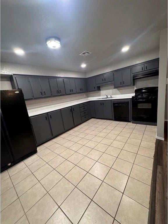 1412 NW 96th St, Oklahoma City, OK 73114 - kitchen with black appliances, light countertops, light tile patterned floors, under cabinet range hood, and recessed lighting
