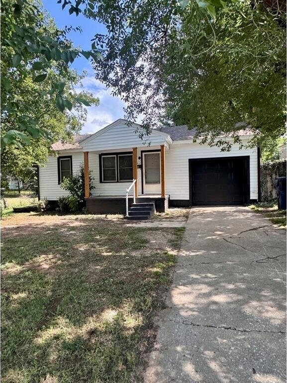 1412 NW 96th St, Oklahoma City, OK 73114 - view of front facade featuring a garage and concrete driveway