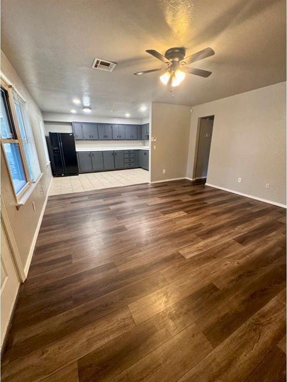 1412 NW 96th St, Oklahoma City, OK 73114 - unfurnished living room featuring dark wood-style floors and ceiling fan