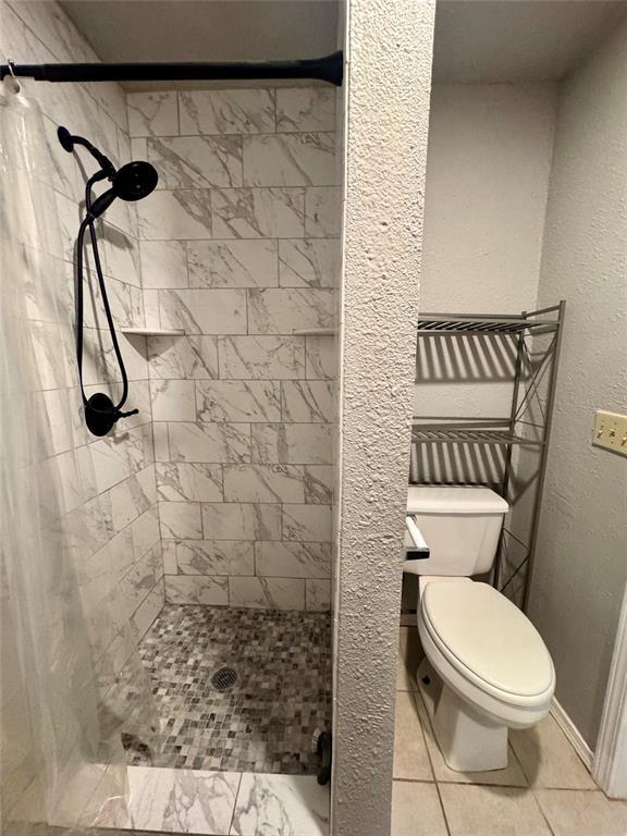 1412 NW 96th St, Oklahoma City, OK 73114 - bathroom with a stall shower and tile patterned floors