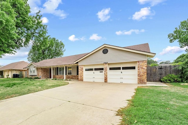 2805 Tudor Rd, Oklahoma City, OK 73127 - ranch-style home with an attached garage, concrete driveway, and brick siding