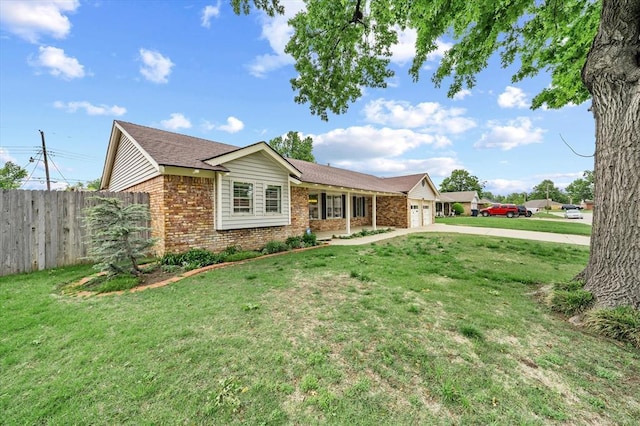 2805 Tudor Rd, Oklahoma City, OK 73127 - ranch-style home featuring brick siding, an attached garage, and driveway