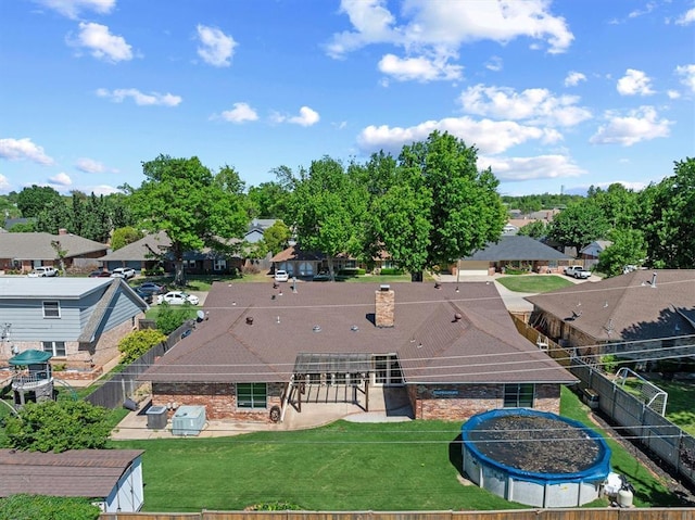 2805 Tudor Rd, Oklahoma City, OK 73127 - rear view of house with a fenced backyard, a residential view, and a chimney