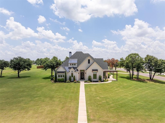 4716 Moulin Rd, Edmond, OK 73034 - view of front of house featuring a front lawn, a chimney, and a shingled roof
