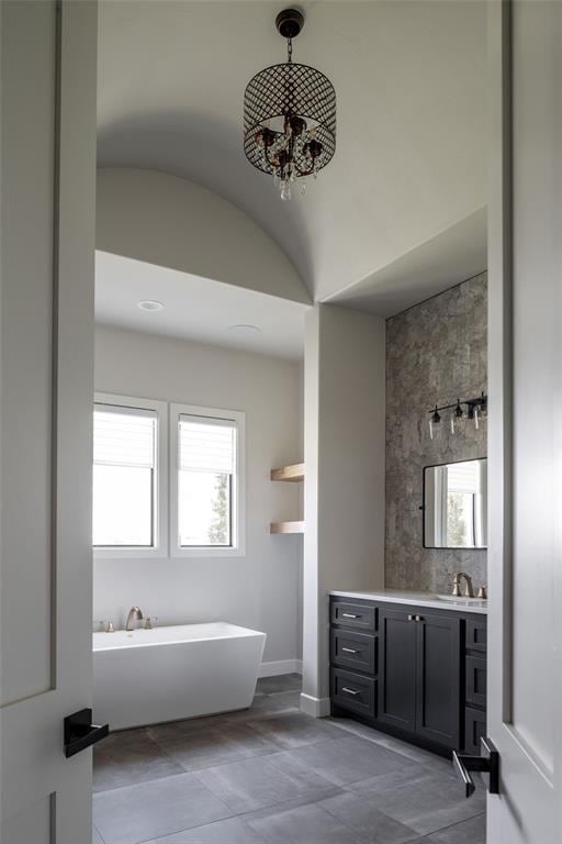 4716 Moulin Rd, Edmond, OK 73034 - bathroom featuring a freestanding tub, vanity, plenty of natural light, and tile patterned floors