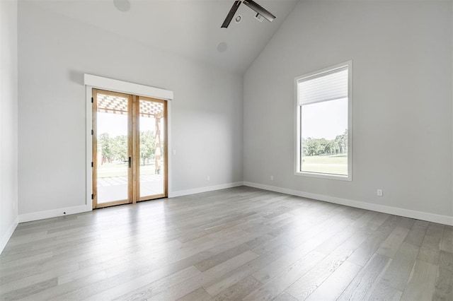 4716 Moulin Rd, Edmond, OK 73034 - unfurnished room featuring healthy amount of natural light, a ceiling fan, wood finished floors, and high vaulted ceiling