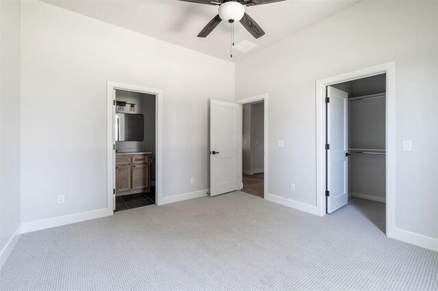 4716 Moulin Rd, Edmond, OK 73034 - unfurnished bedroom with carpet flooring, a spacious closet, ensuite bathroom, and a ceiling fan