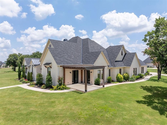 4716 Moulin Rd, Edmond, OK 73034 - rear view of property with a lawn, a shingled roof, brick siding, and a patio area