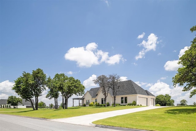 4716 Moulin Rd, Edmond, OK 73034 - view of front facade featuring an attached garage, driveway, a front lawn, and stucco siding
