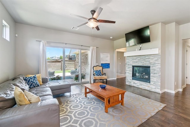 637 NW 179th Cir, Edmond, OK 73012 - living area with ceiling fan, healthy amount of natural light, wood finished floors, and a fireplace